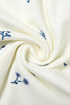 Rosalie White close-up of the swirled rib-knit fabric with small blue floral print.