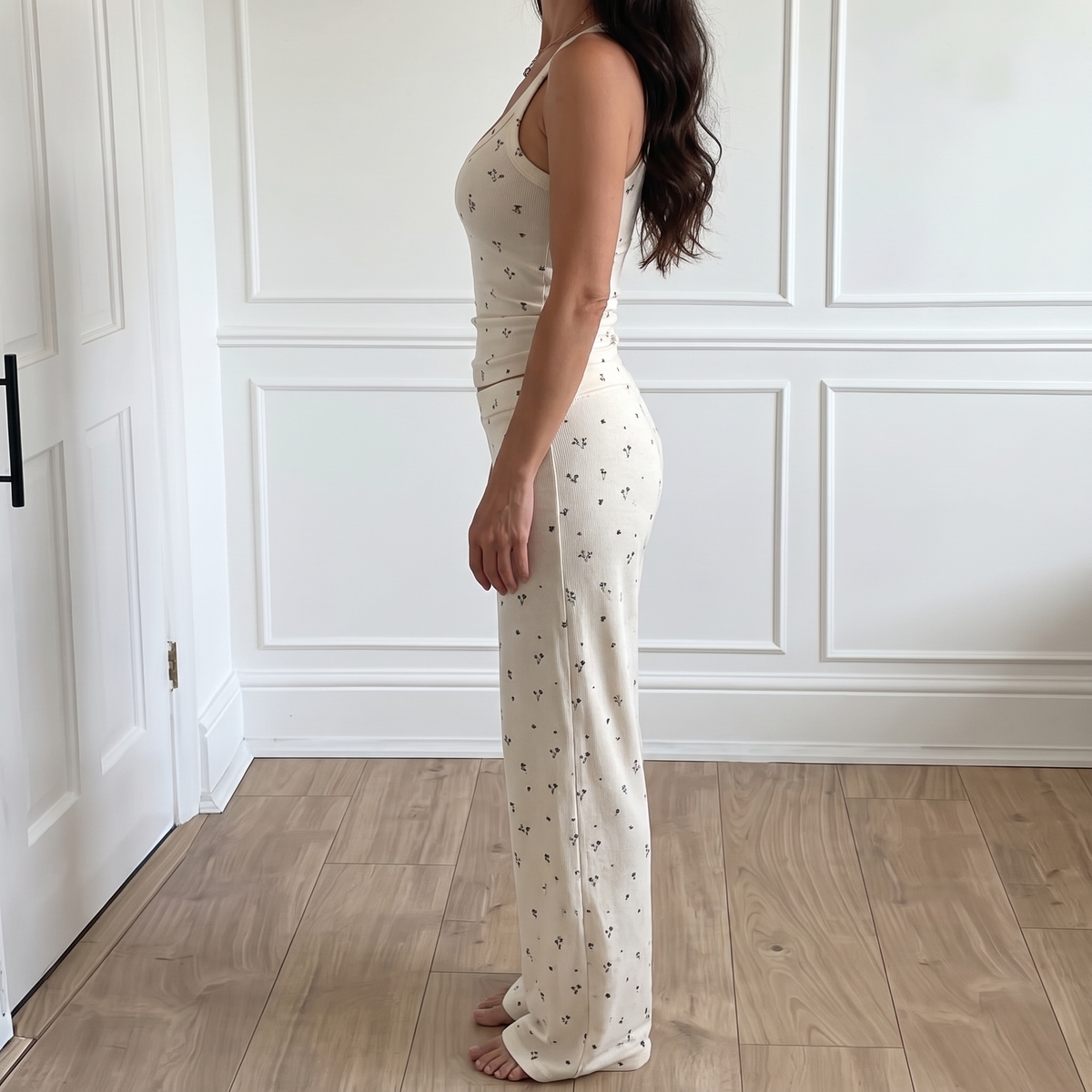 Rosalie White matching set shown from the side, showing the fitted tank and straight flowing pant leg.