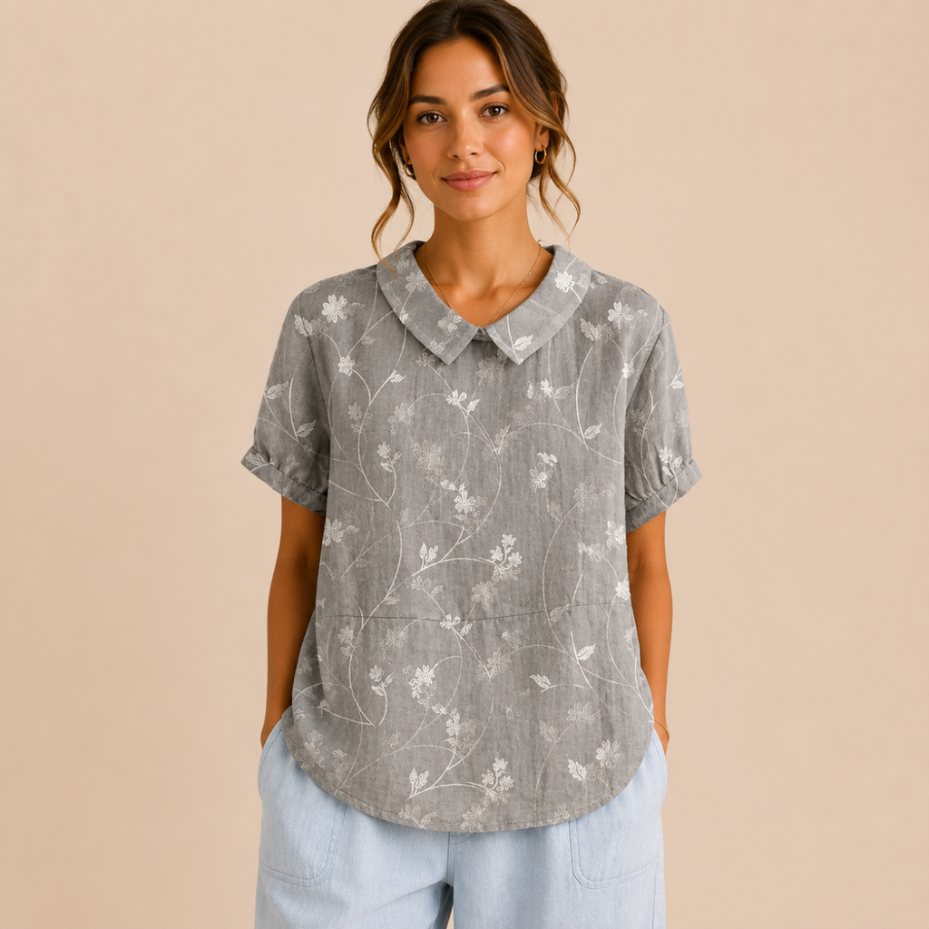 Front view of the Rosalind Blouse Floral-Print Lightweight Collared in gray, featuring a lightweight floral print, collared neckline, and relaxed fit. Designed by Bella Hudson.