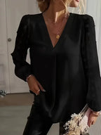 Front view of the Rosalind Blouse Long-Sleeve Sheer-Sleeve Swiss-Dot in black, featuring a V-neckline, sheer Swiss-dot long sleeves, gathered cuffs, and a relaxed flowing silhouette. Designed by Bella Hudson.