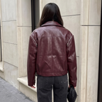 Back view of the Rosalind Jacket Faux-Leather Cropped in dark brown, highlighting the clean back design, structured seams, long sleeves, and relaxed cropped silhouette. Designed by Bella Hudson.