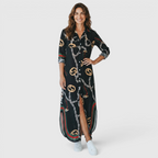 Front view of the Rosamund Shirt Dress Printed Long-Sleeve Button-Front in black, featuring a collared neckline, button-front closure, long sleeves, printed fabric, and a relaxed shirt dress silhouette. Designed by Bella Hudson.