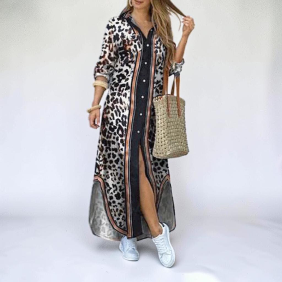 Front view of the Rosamund Shirt Dress Printed Long-Sleeve Button-Front in brown, featuring a collared neckline, button-front closure, printed fabric, side slit, and a flowing maxi silhouette. Designed by Bella Hudson.