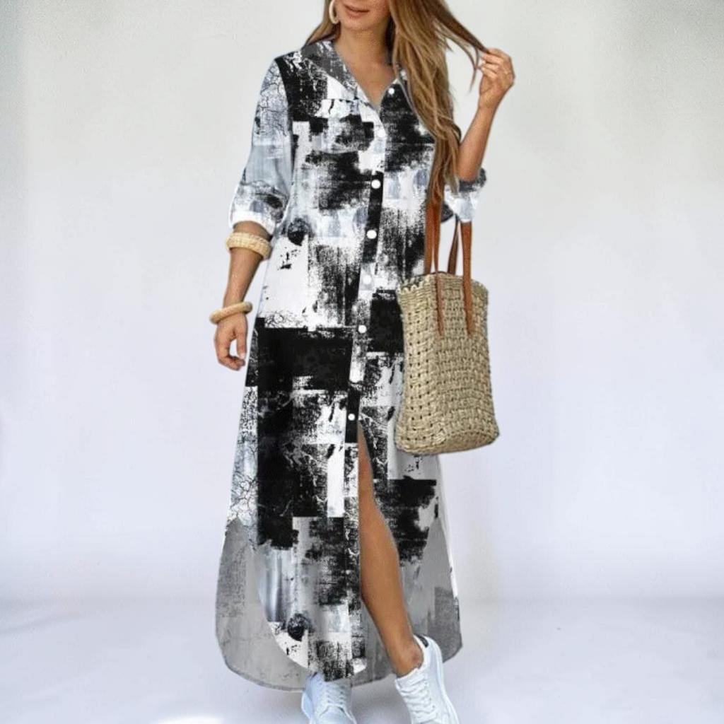Front view of the Rosamund Shirt Dress Printed Long-Sleeve Button-Front in dark gray, featuring a collared neckline, button-front closure, printed fabric, side slit, and a relaxed maxi silhouette. Designed by Bella Hudson.