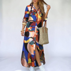 Front view of the Rosamund Shirt Dress Printed Long-Sleeve Button-Front in orange, featuring a collared neckline, button-front closure, geometric print, side slit, and a relaxed maxi silhouette. Designed by Bella Hudson.