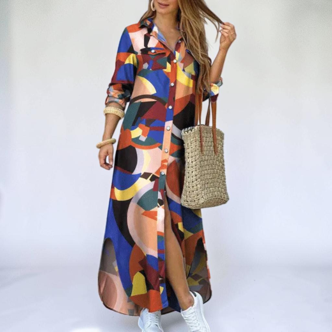 Front view of the Rosamund Shirt Dress Printed Long-Sleeve Button-Front in orange, featuring a collared neckline, button-front closure, geometric print, side slit, and a relaxed maxi silhouette. Designed by Bella Hudson.