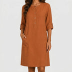 Front view of rust linen midi dress with rolled sleeves and side pockets by BELLA HUDSON