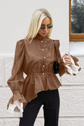 Sabrina Brown ruffle-hem blouse with pearl-style buttons, stand collar and lace-trimmed cuffs styled with black pants.