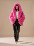 Sabrina Pink faux-fur hooded jacket featuring a cropped fit, oversized hood, plush exterior, and relaxed long sleeves