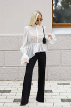Sabrina White sheer ruffle-hem blouse with lace-trim cuffs styled with black wide-leg pants.