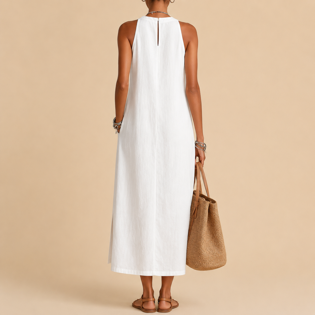 Close-up detail of the Saffia Lightweight Cotton-Linen Sleeveless Midi Dress in white highlighting the high neckline, decorative lace panel detailing, lightweight cotton-linen texture, and relaxed construction. Designed by Bella Hudson.