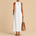 Close-up detail of the Saffia Lightweight Cotton-Linen Sleeveless Midi Dress in white highlighting the high neckline, decorative lace panel detailing, lightweight cotton-linen texture, and relaxed construction. Designed by Bella Hudson.