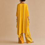Back view of the Saffron Boho Two-Piece Set Draped Floral-Print in yellow showcasing the elegant draped top and relaxed wide-leg silhouette, designed by Bella Hudson.