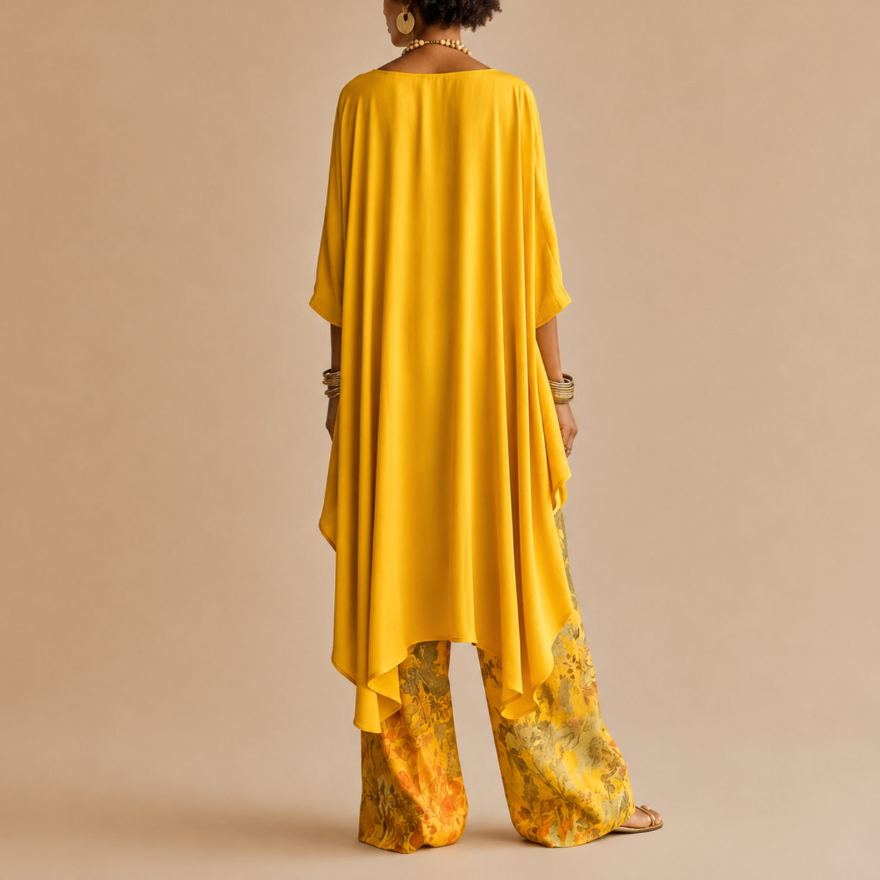 Back view of the Saffron Boho Two-Piece Set Draped Floral-Print in yellow showcasing the elegant draped top and relaxed wide-leg silhouette, designed by Bella Hudson.