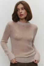 Selena Beige sheer-knit crewneck sweater worn with brown pants, shown from the front with a ribbed neckline, cuffs, and hem.