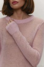 Selena Pink sheer-knit crewneck sweater close-up of the ribbed neckline and cuff on the lightweight knit.