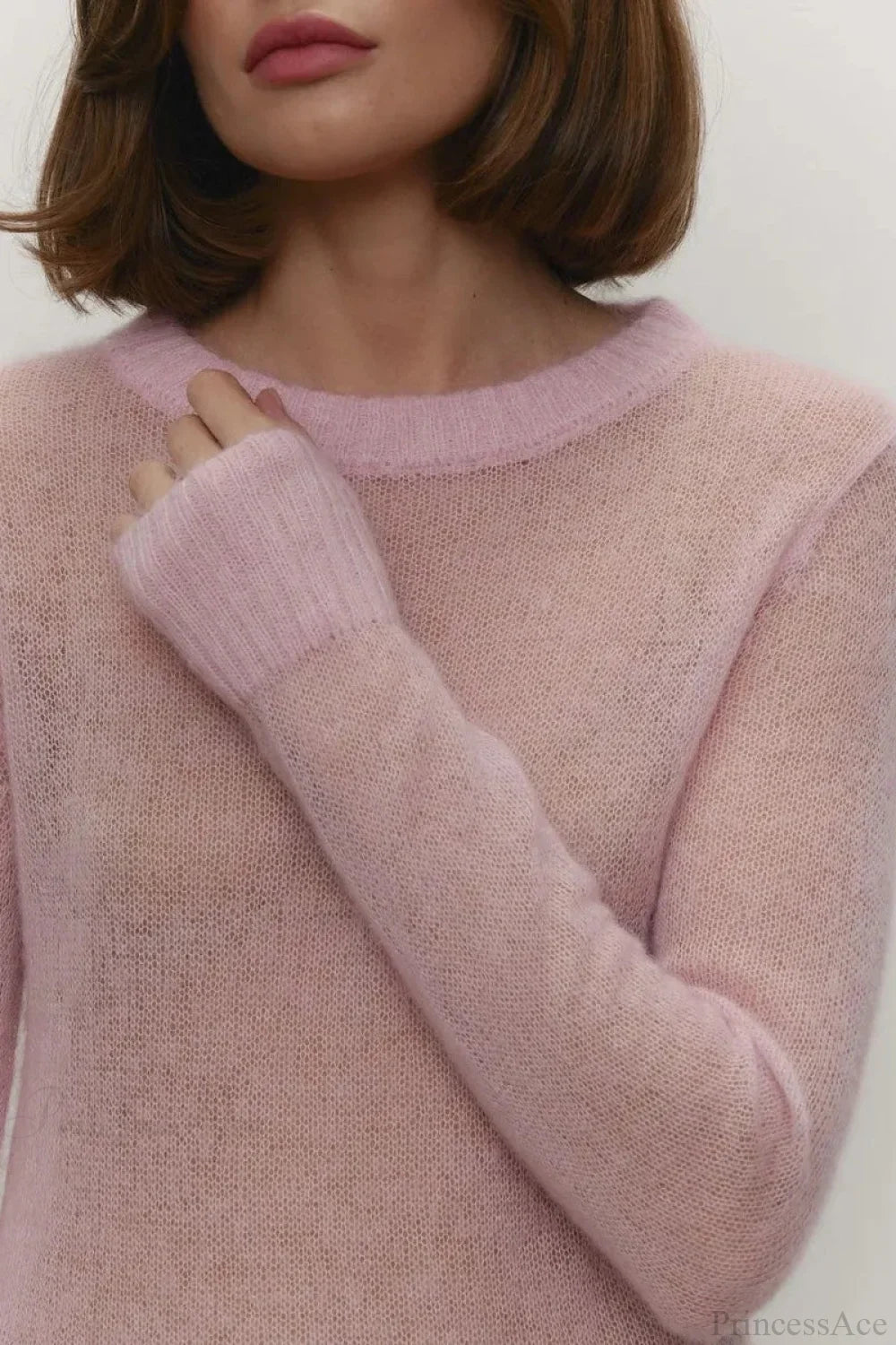 Selena Pink sheer-knit crewneck sweater close-up of the ribbed neckline and cuff on the lightweight knit.