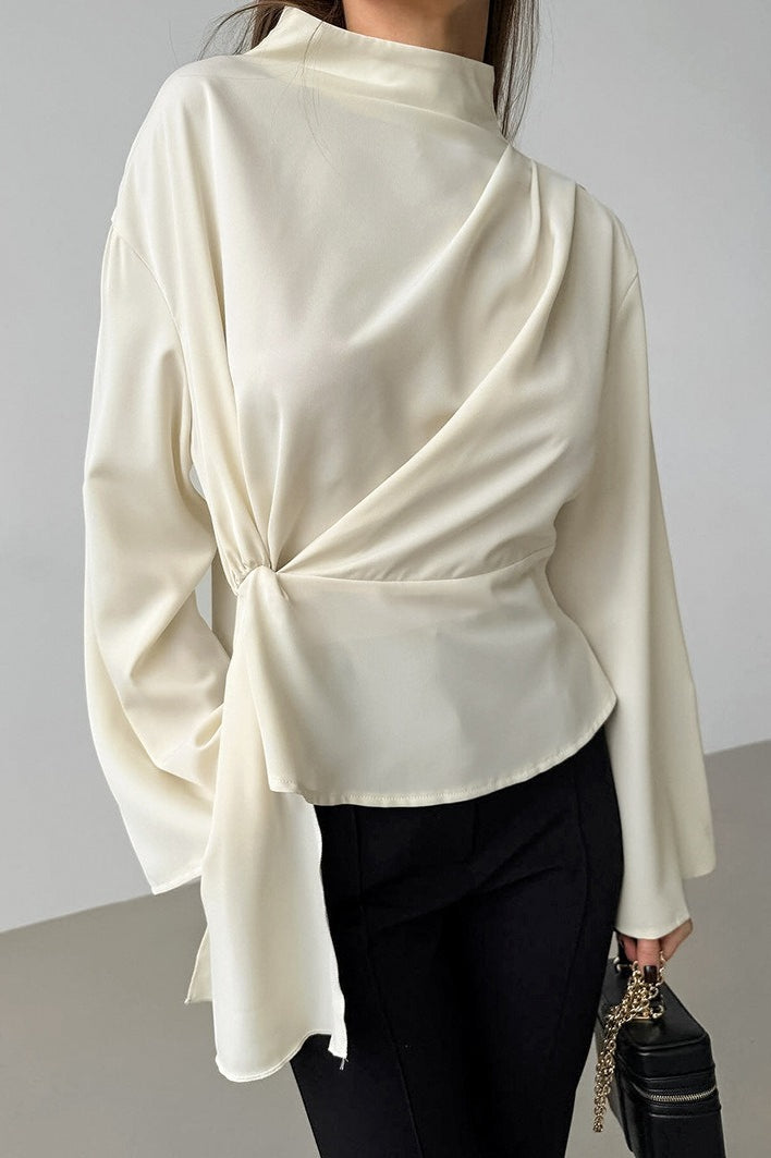 Selene Apricot blouse close-up of the mock neckline, asymmetric drape and gathered waist.