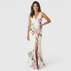 Front view of the Seraphine Maxi Dress Floral-Print Bodycon V-Neck in white, featuring a V-neckline, sleeveless design, bodycon silhouette, vibrant floral print, and a flowing fishtail hem. Designed by Bella Hudson.