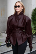 Serena Red faux leather belted jacket front detail showing the fitted waist, matching belt, long sleeves, and flared peplum-style hem
