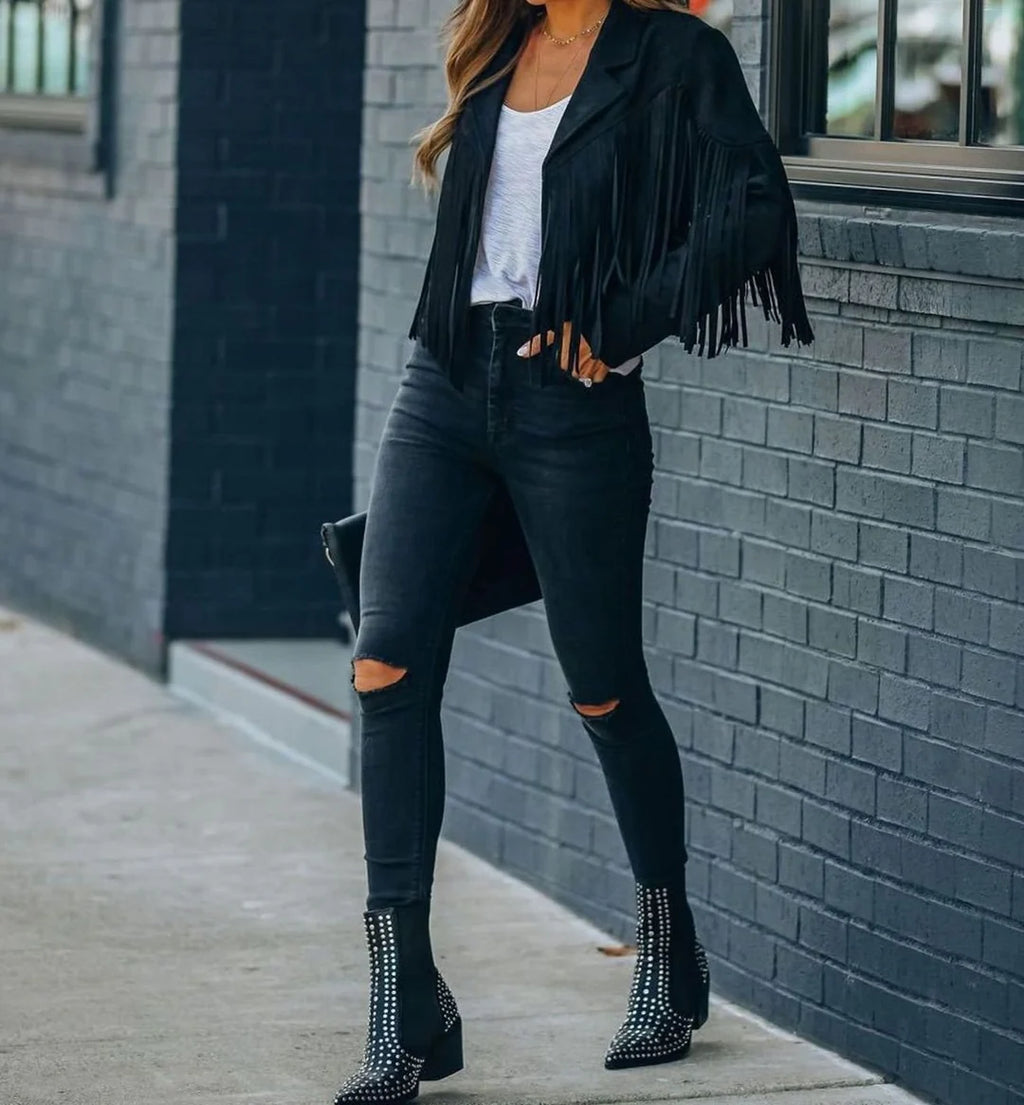 Sienna Black faux-suede moto jacket featuring a cropped silhouette, long fringe detailing, notched lapels, and fitted long sleeves