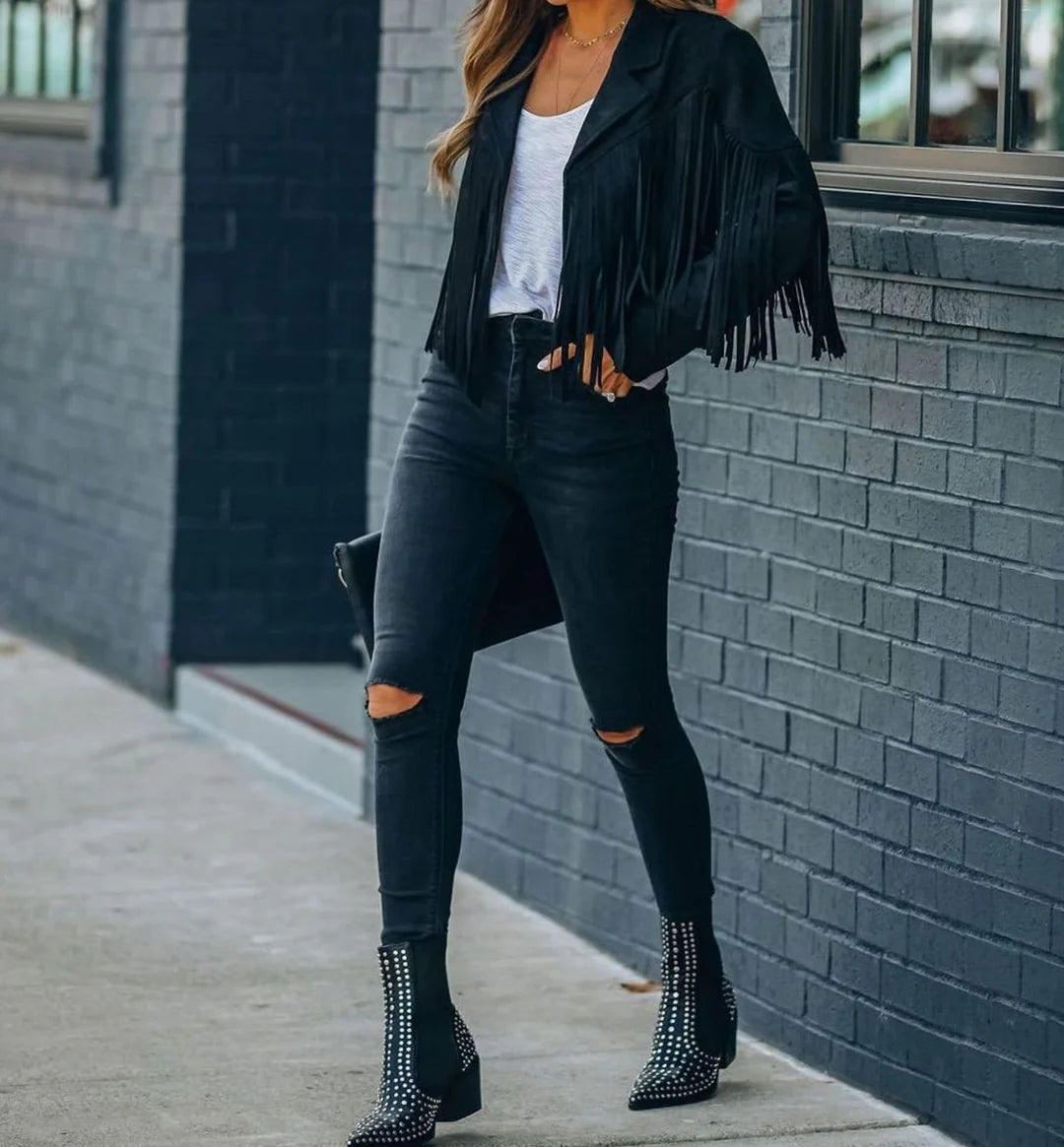 Sienna Black faux-suede moto jacket featuring a cropped silhouette, long fringe detailing, notched lapels, and fitted long sleeves