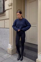 Sienna Navy Blue fuzzy sweater styled with black leggings and black boots in a full-body look.