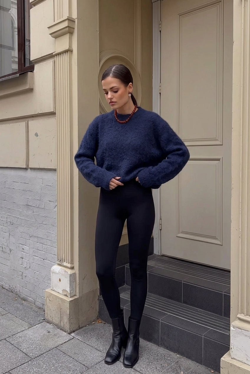 Sienna Navy Blue fuzzy sweater styled with black leggings and black boots in a full-body look.