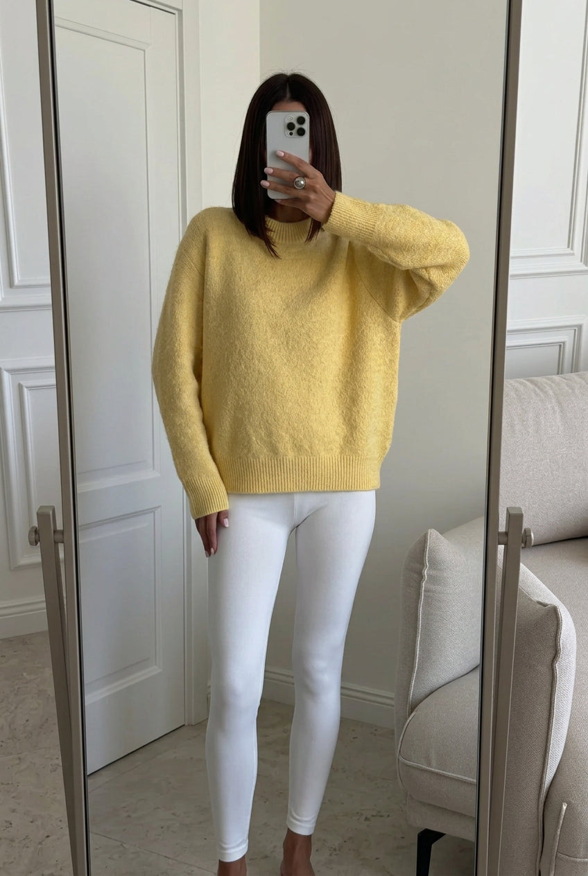 Sienna Yellow oversized sweater worn with white leggings in a mirror selfie.