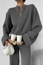 Sloane Gray close-up of the ribbed zip-front jacket with round neckline and folded cuffs.