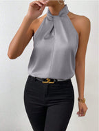 Front view of the Solenne Top Satin Halter Tie-Neck in gray, featuring a halter tie neckline, sleeveless silhouette, and smooth satin fabric. Designed by Bella Hudson.