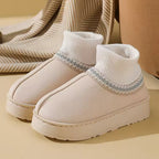 Sophie Beige slip-on ankle slippers featuring a ribbed knit collar, decorative trim, rounded toe, and thick sole