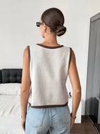 Sophie Beige knit sweater vest shown from the back, featuring a sleeveless design, round neckline, and ribbed hem