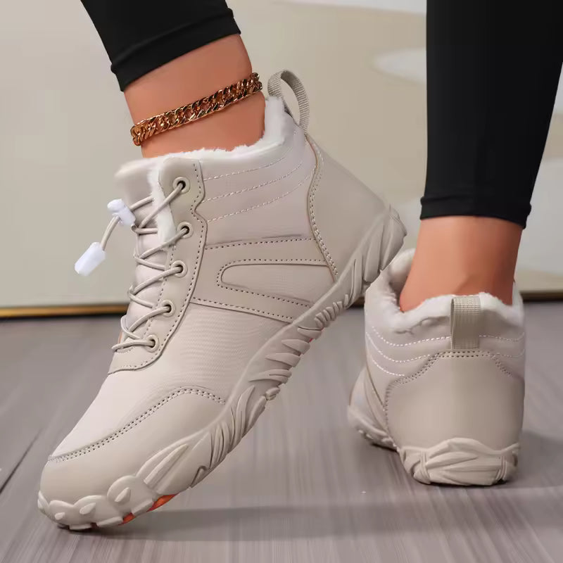 Sophie Beige quilted ankle snow boots with lace-up closure, plush lining, and textured outsole, shown on feet
