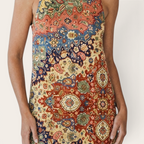 Close-up detail of the Sunniva Midi Dress Sleeveless Bohemian-Print Rustic in yellow, featuring the sleeveless round neckline, intricate bohemian print, and lightweight textured fabric. Designed by Bella Hudson.