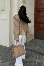 Tahlia Khaki cropped blazer shown from the back with structured shoulders and a relaxed cropped length over white wide-leg pants.