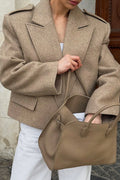 Tahlia Khaki cropped blazer shown close up with wide notched lapels, epaulets and a front flap pocket, styled with white pants.