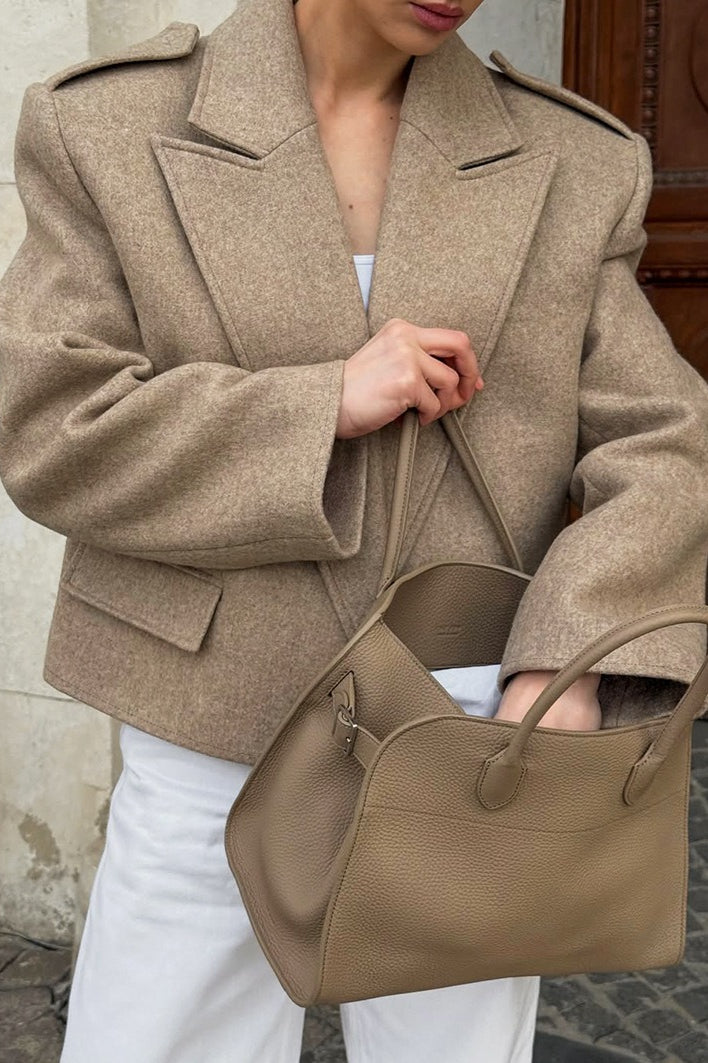 Tahlia Khaki cropped blazer shown close up with wide notched lapels, epaulets and a front flap pocket, styled with white pants.