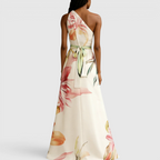Back view of the Talia Maxi Dress Floral-Print Satin with Halter Neck in pink, highlighting the halter-back design, flowing satin fabric, and graceful maxi-length silhouette. Designed by Bella Hudson.