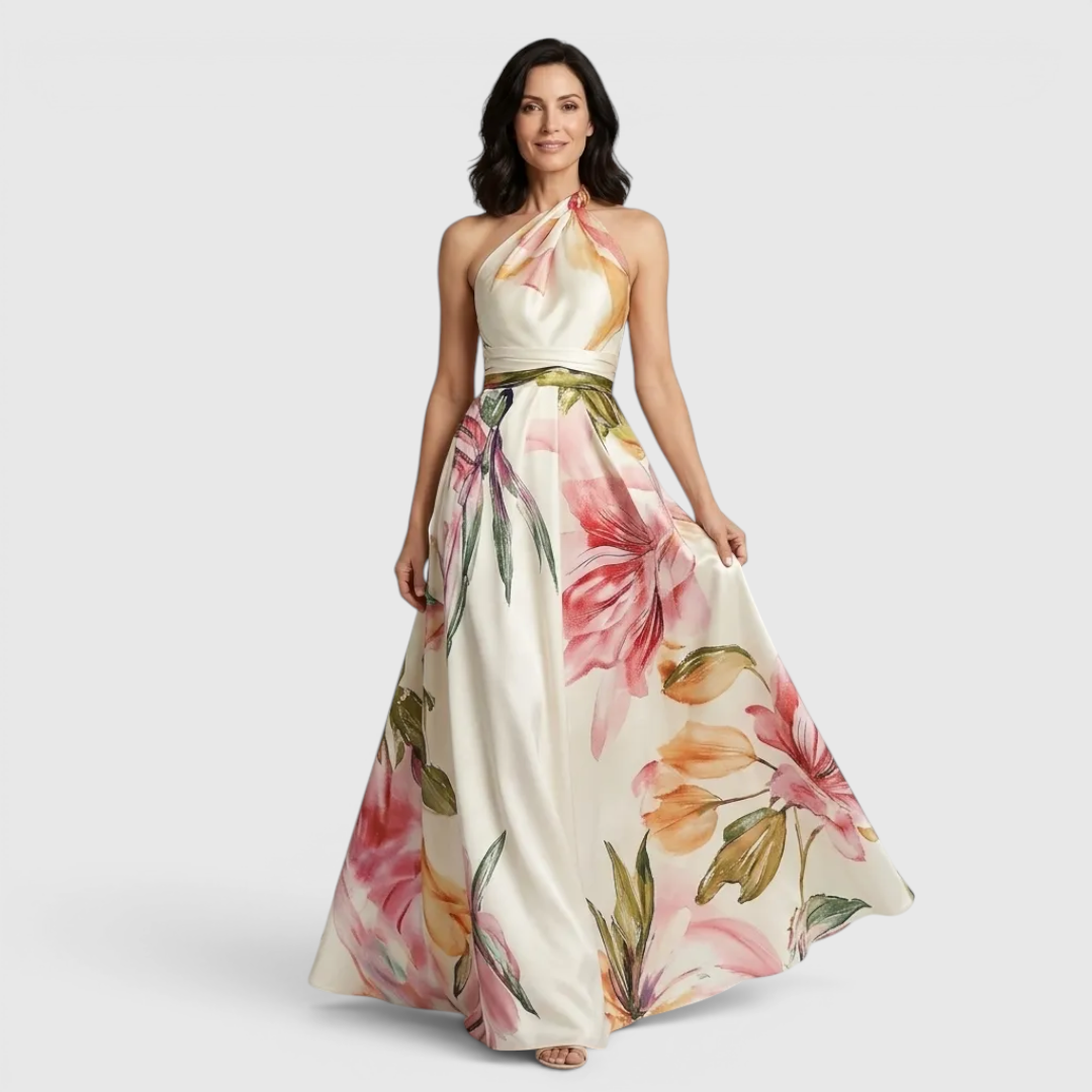 Front view of the Talia Maxi Dress Floral-Print Satin with Halter Neck in pink, featuring a halter neckline, satin finish, flowing A-line skirt, and oversized floral print. Designed by Bella Hudson.