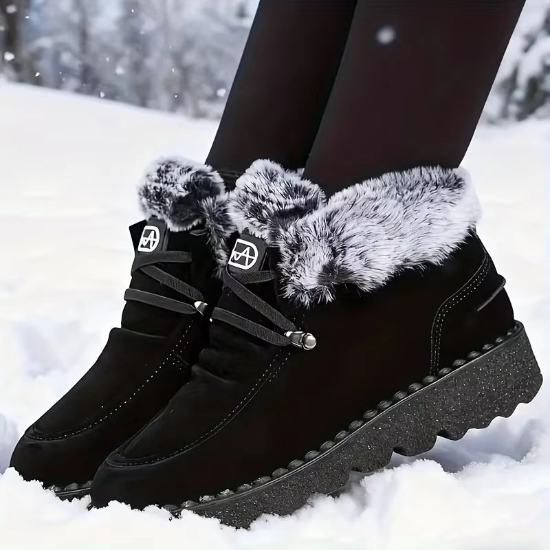 Tessa Black faux suede snow boots with plush faux fur collar, lace-up closure, and textured outsole, shown on feet