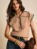 Tessa Brown collared knit sweater vest with contrasting trim and partial button placket, styled with jeans