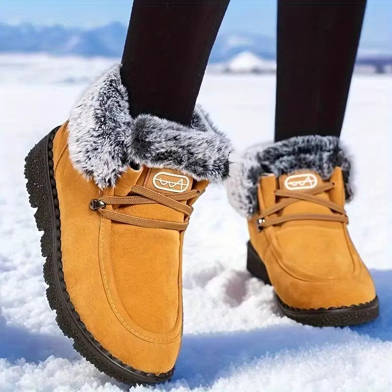 Tessa Brown snow boots with faux fur lining, adjustable lace-up front, and thick textured soles