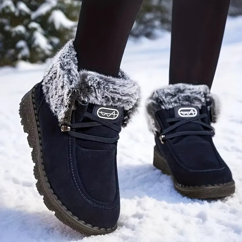 Tessa Dark Blue snow boots with plush faux fur collar, lace-up closure, and rounded toe, shown on feet
