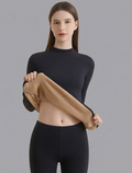 Fitted thermal base layer set featuring a high-neck long-sleeve top and matching leggings, with fabric lifted to show the interior