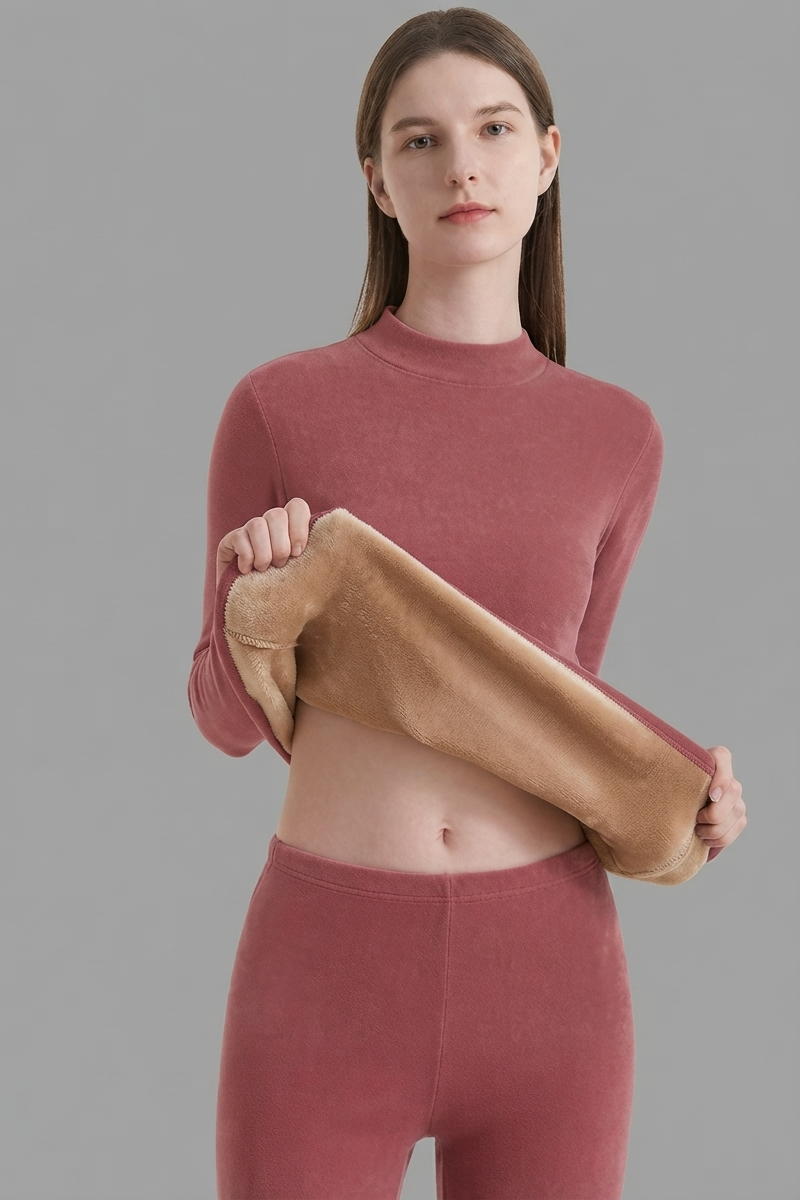 Women's fitted thermal base layer set featuring long sleeves, a high neckline, and matching high-waisted leggings