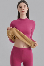 Women's two-piece thermal underwear set with a fitted long-sleeve top and matching leggings, showing the inner fabric
