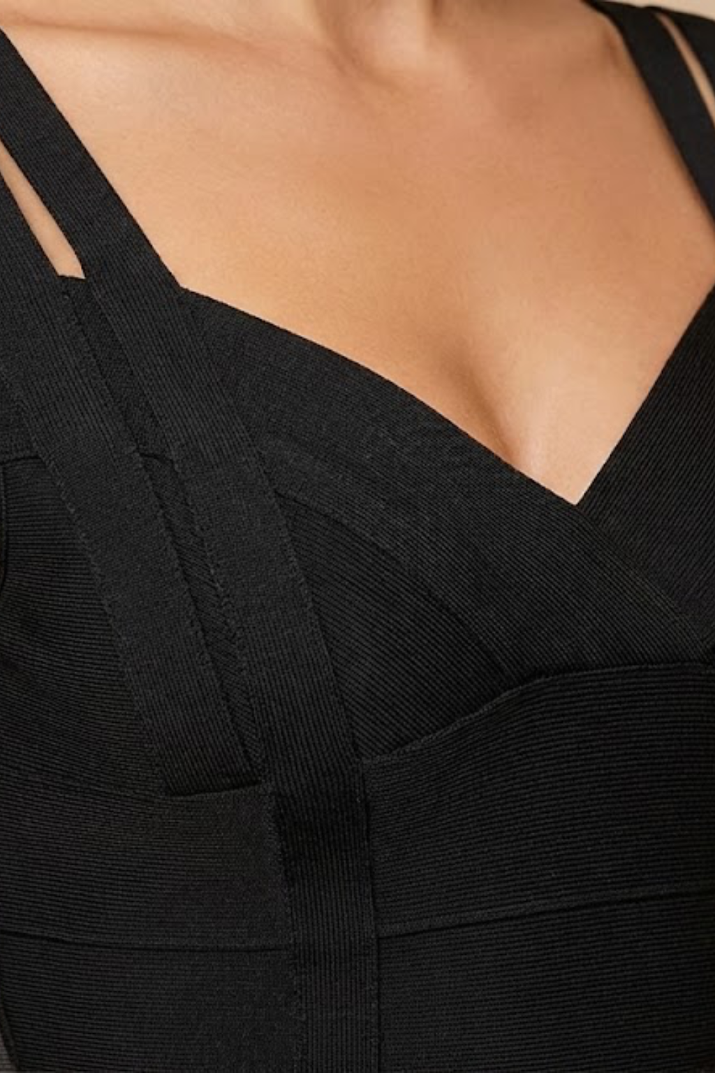 Close-up detail view of the Valentina Bandage Midi Dress Off-Shoulder Body-Hugging in black, highlighting the V-shaped neckline, off-shoulder straps, and fitted bodice construction. Designed by Bella Hudson.