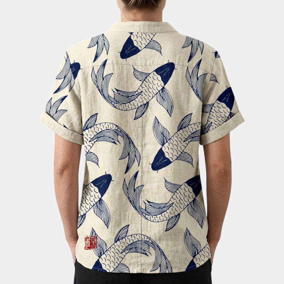 Back view of the Vintage Fish-Print Linen Shirt in beige, highlighting the relaxed silhouette, short sleeves, and all-over fish print. Designed by Bella Hudson.