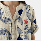 Close-up detail of the Vintage Fish-Print Linen Shirt in beige, featuring the band collar, button-front placket, and intricate fish print on textured fabric. Designed by Bella Hudson.